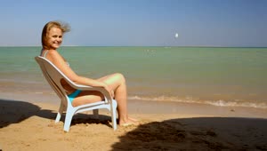 Download Stock Footage Woman Resting In A Chair At The Shore Live Wallpaper Free