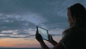 Download Stock Footage Woman Taking Photos At Dusk Live Wallpaper Free