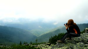 Download Stock Footage Woman Taking Photos In The Top Of The Mountain Live Wallpaper Free