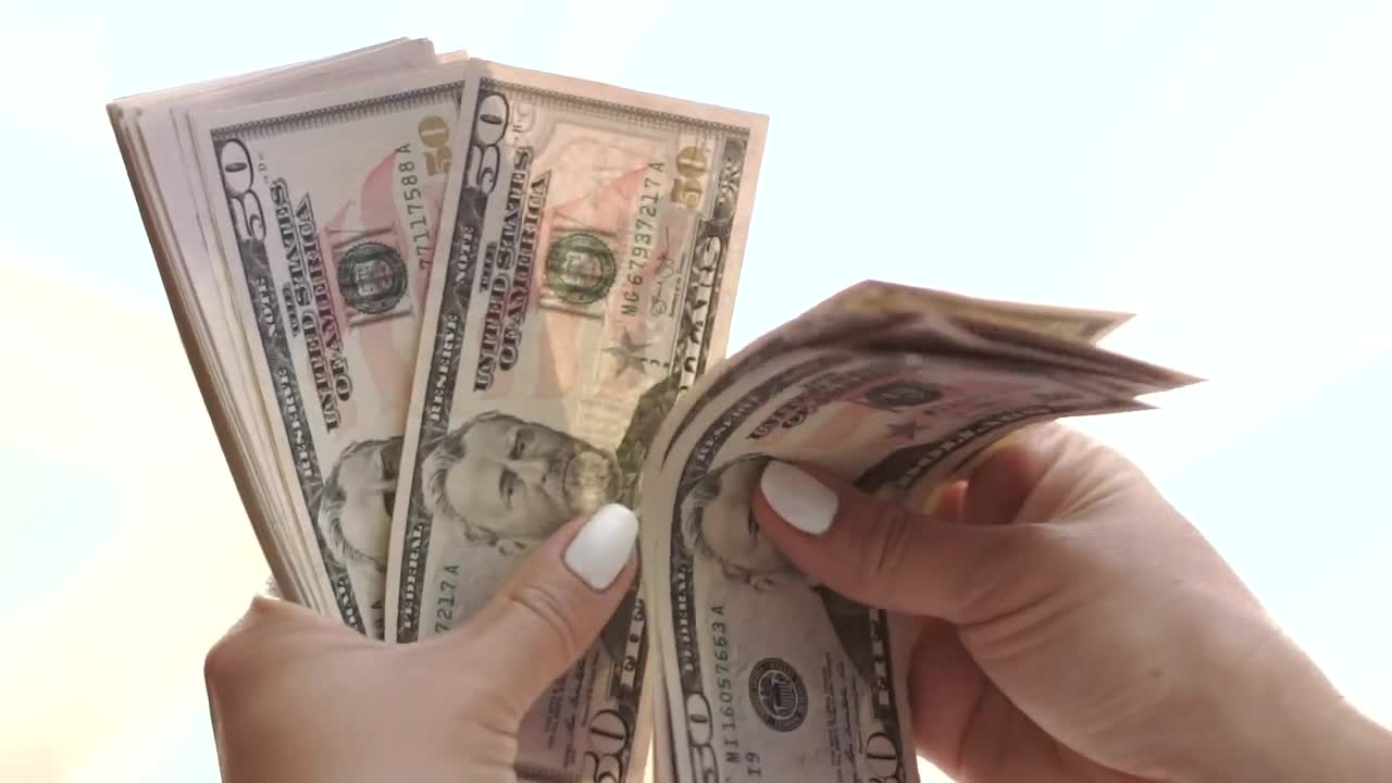 Download Stock Footage Woman Counting Dollars Live Wallpaper Free