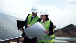 Download Stock Footage Workers Checking A Blueprint In The Solar Field Live Wallpaper Free