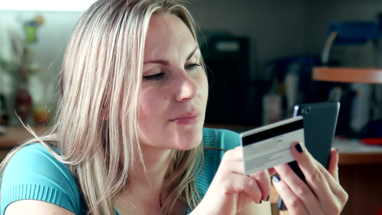 Download Stock Footage Young Woman Using The Phone With Credit Card Live Wallpaper Free