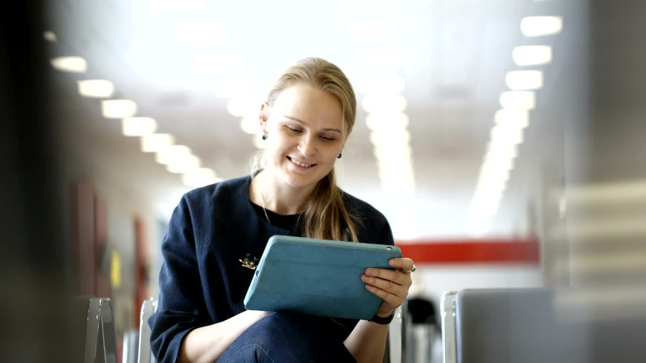 Download Stock Footage Woman Using A Tablet In A Waiting Room Live Wallpaper Free