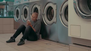 Download Stock Footage Woman Waiting For Her Laundry To Finish Live Wallpaper Free