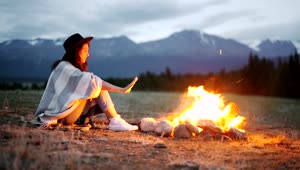 Download Stock Footage Woman Warming Her Hands Over A Hot Campfire Live Wallpaper Free
