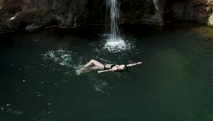 Download Stock Footage Woman Swimming In A Pond With A Little Waterfall Live Wallpaper Free
