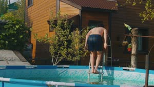 Download Stock Footage Young Man Jumping To An Inflatable Pool Live Wallpaper Free