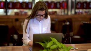 Download Stock Footage Young Woman Working On A Laptop And Talking On The Live Wallpaper Free