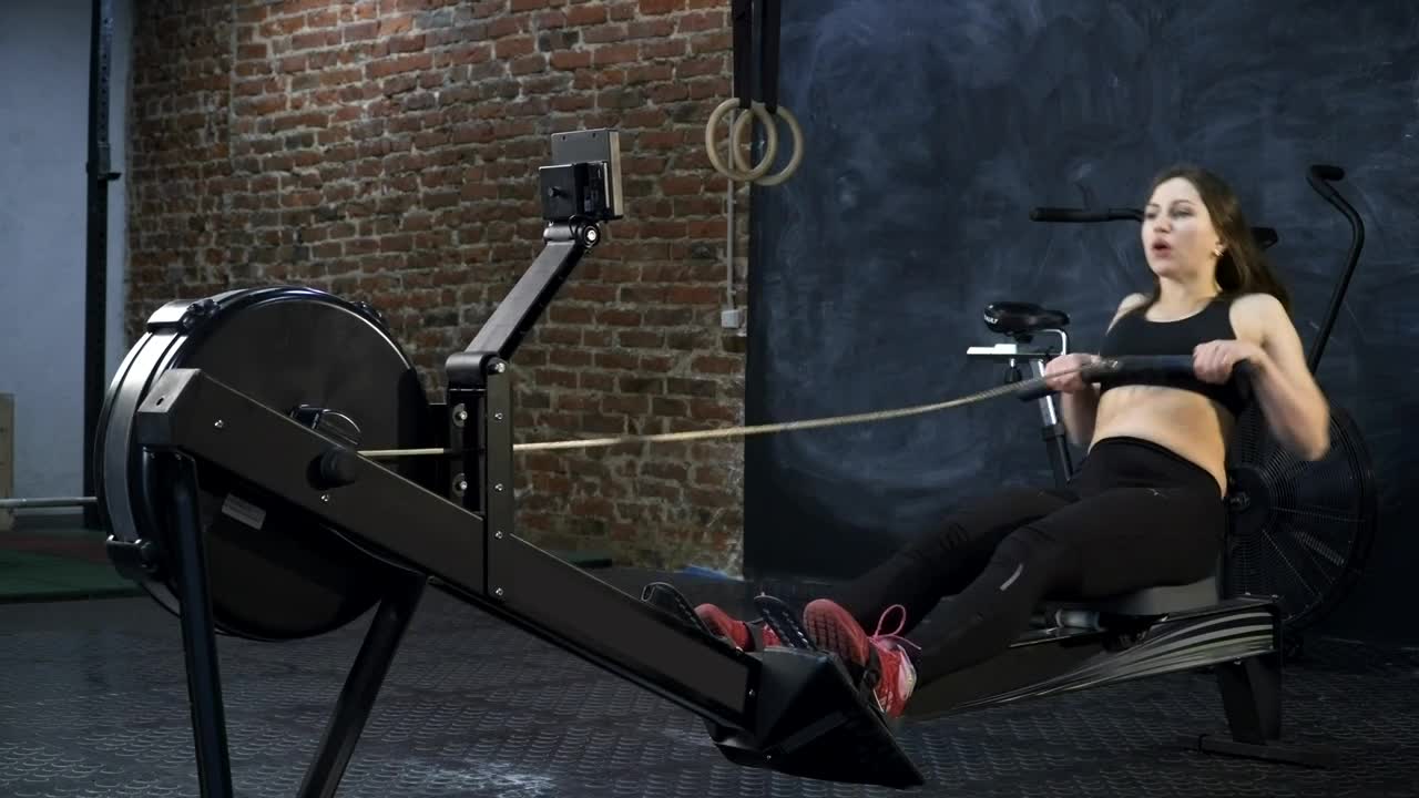 Download Stock Footage Woman Using A Rowing Machine Live Wallpaper Free