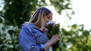 Download Stock Footage Woman In Denim Jacket Smelling Flowers On Spring Day Live Wallpaper Free