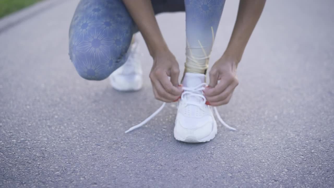 Download Stock Footage Woman Tying The Laces Of Her Sneakers Live Wallpaper Free