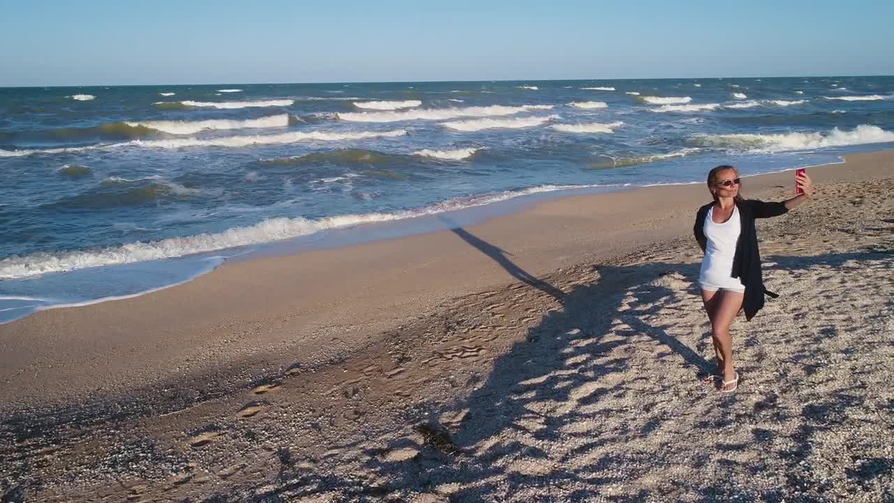 Download Stock Footage Woman Taking Selfies In The Beach Live Wallpaper Free