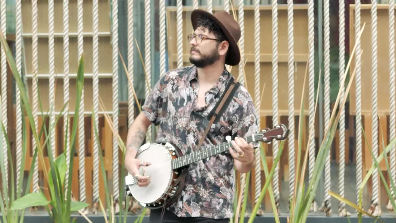 Download Stock Footage Young Man Playing And Singing With A Banjo In A Live Wallpaper Free