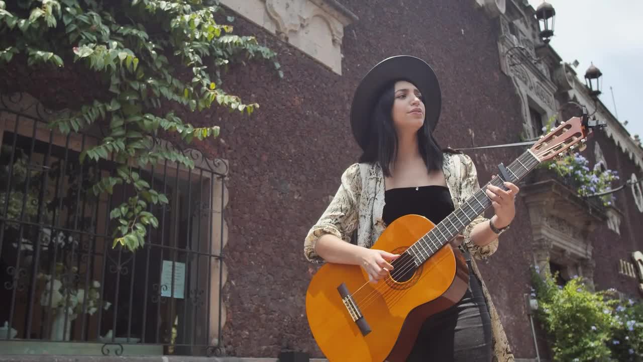 Download Stock Footage Young Woman Playing Guitar On An Old Street In The Live Wallpaper Free