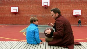 Download Stock Footage Young Man And His Little Brother On The Basketball Playground Live Wallpaper Free