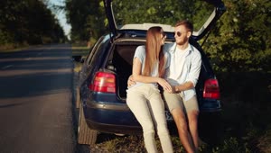 Download Stock Footage Young Couple Kiss In Back Of Car In Sunny Countryside Live Wallpaper Free