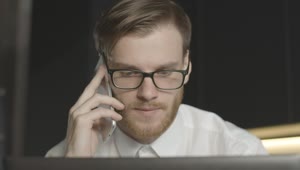 Download Stock Footage Worried Man On Phone Call Stares At Laptop Live Wallpaper Free