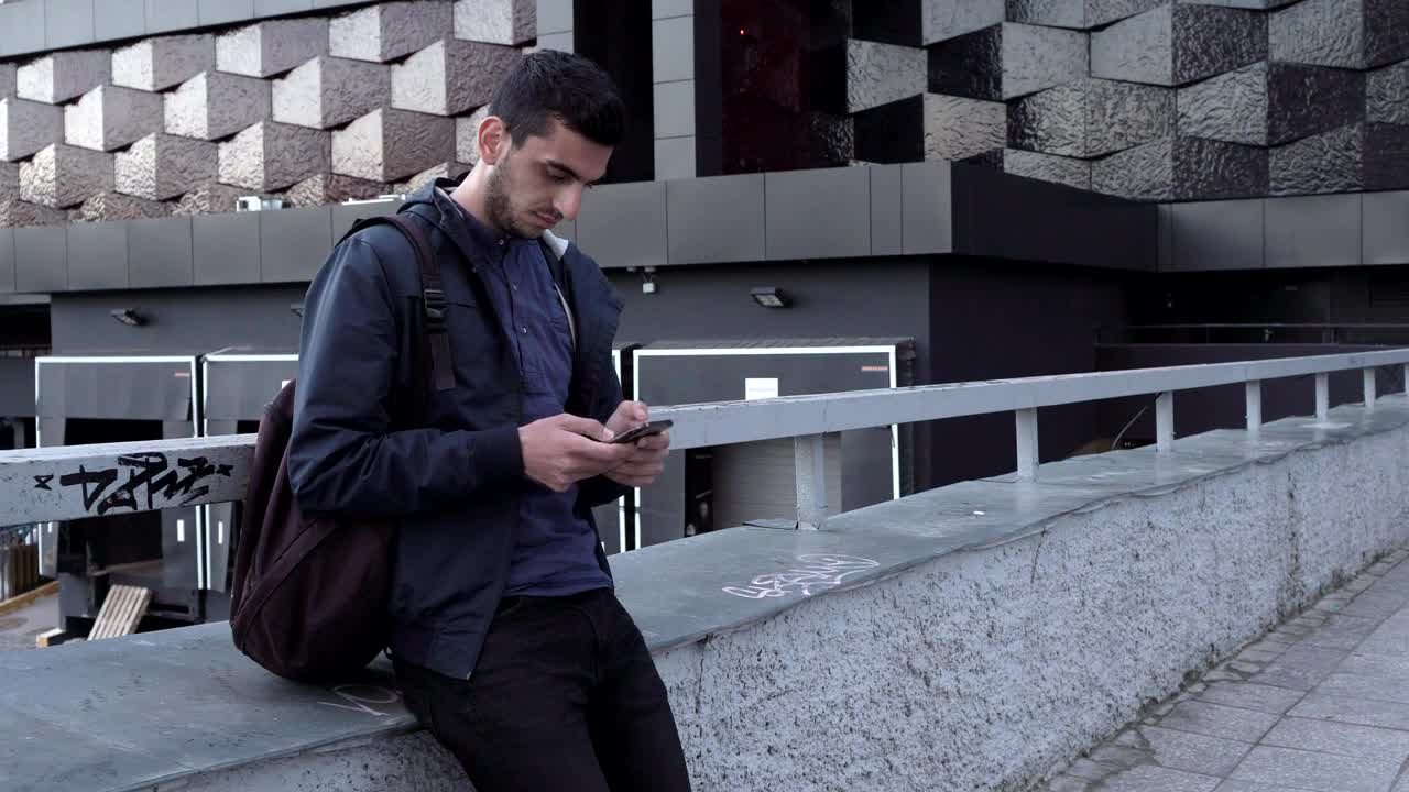 Download Stock Footage Young Man Texting In The City Live Wallpaper Free