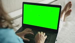Download Stock Footage Woman Types On Greenscreen Laptop On Sofa Live Wallpaper Free