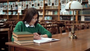 Download Stock Footage Young Woman Learning In Library Smiles At Camera Live Wallpaper Free