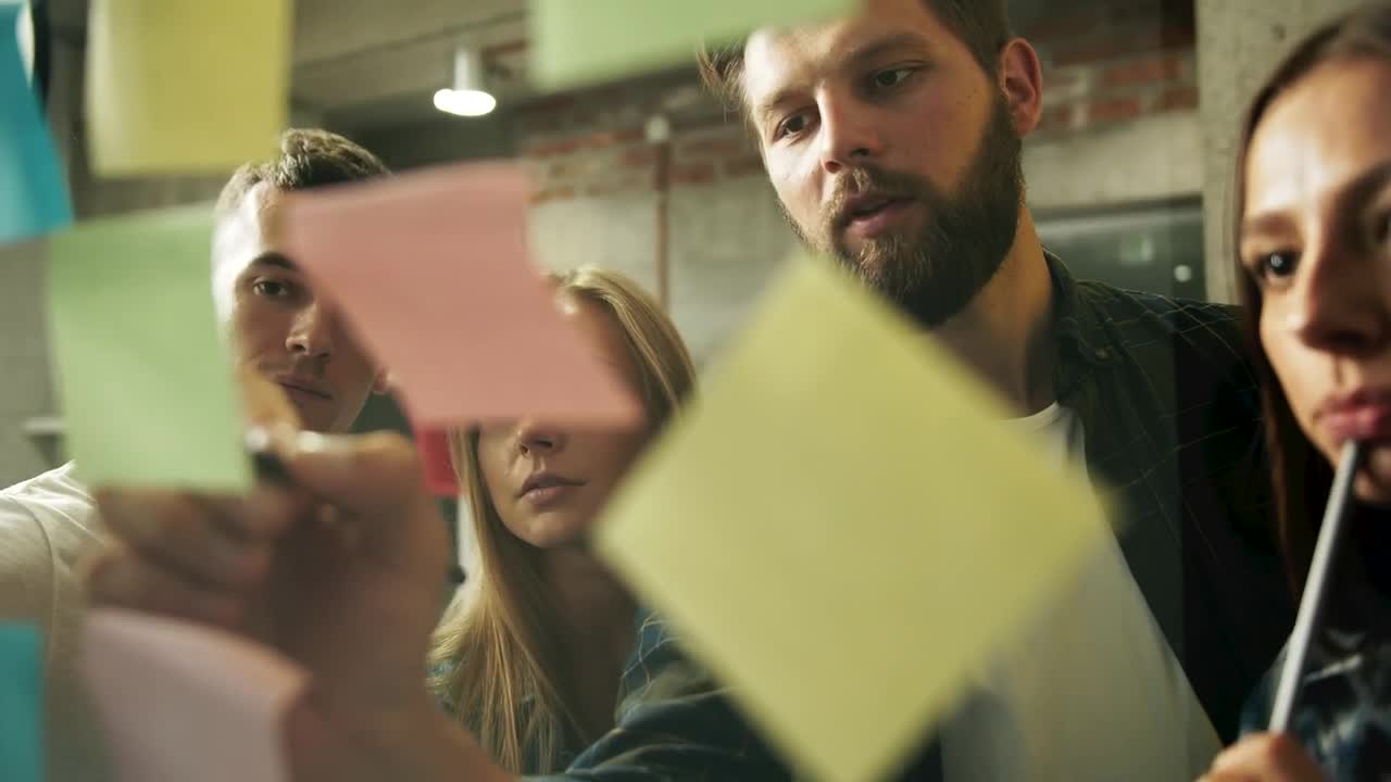 Download Stock Footage Young Team Brainstorms Ideas With Sticky Notes Live Wallpaper Free