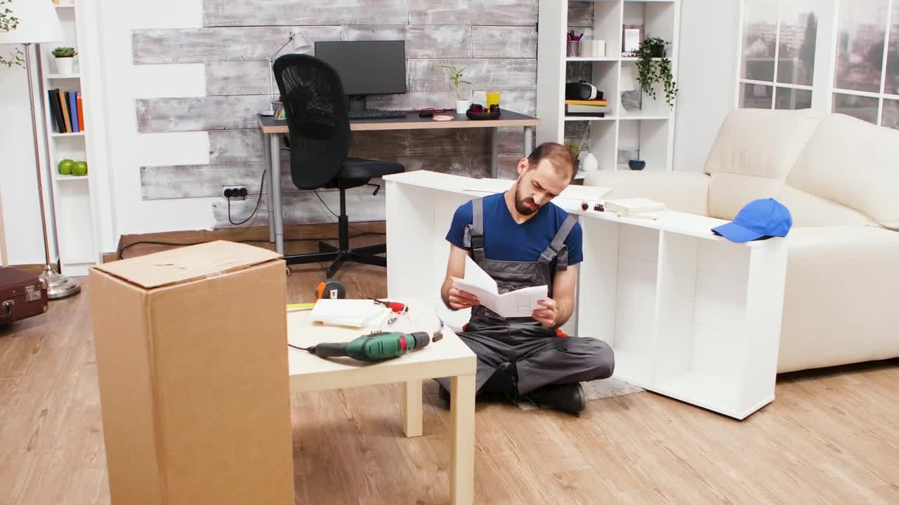 Download Stock Footage Young Man Trying To Build A Bookcase Live Wallpaper Free