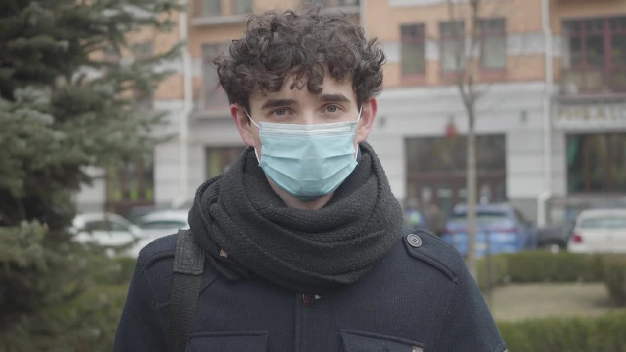 Download Stock Footage Young Man With Face Mask On The Street Live Wallpaper Free