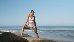 Download Stock Footage Woman Doing Yoga On Boulders On The Beach Live Wallpaper Free